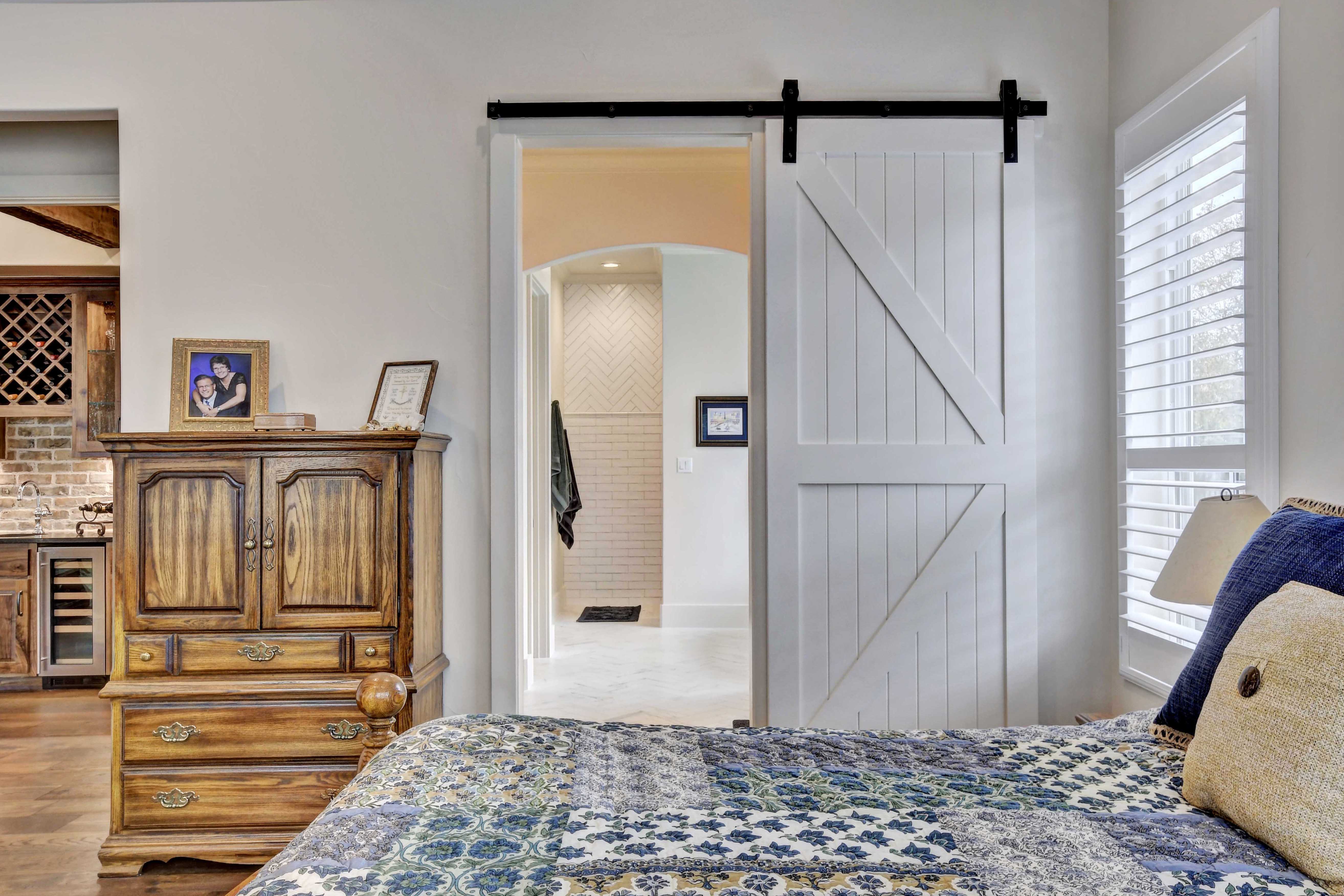 Becker-bathroom-entrance-with-sliding-wood-doors - Godsey Custom Homes